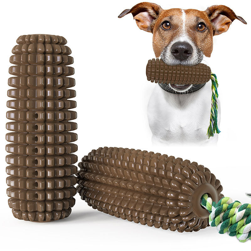 Dog holding brown corn-shaped chew toy with green and yellow rope, durable interactive dog dental toy