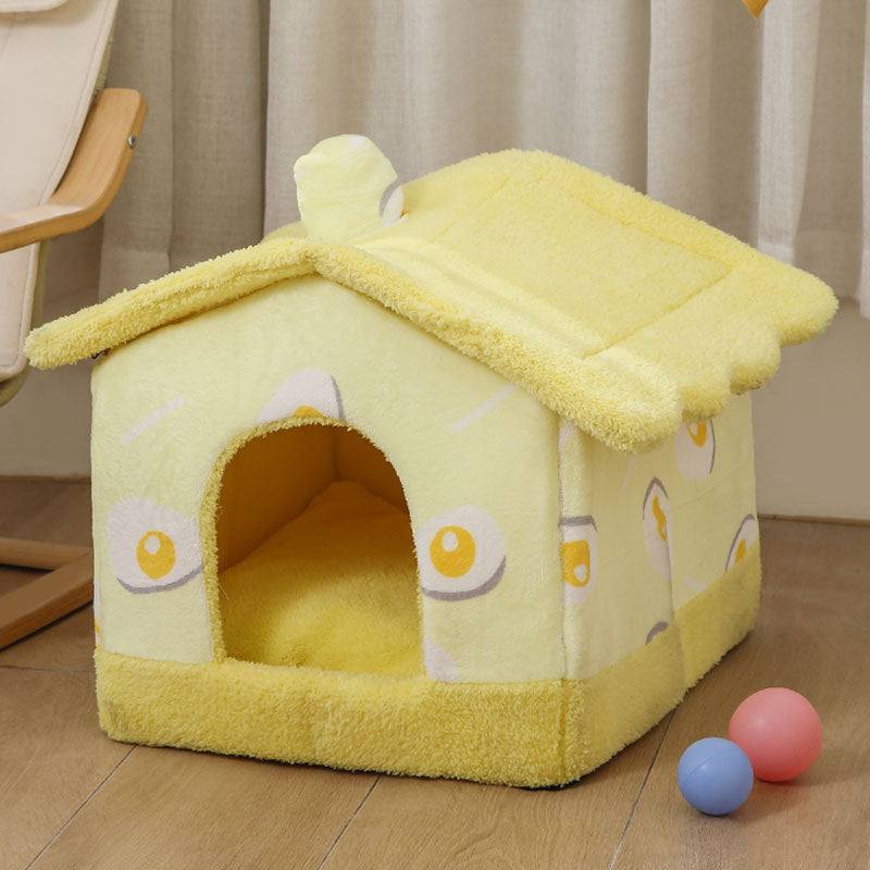 Yellow plush cozy cat house shaped like a fried egg with soft removable cover on wooden floor