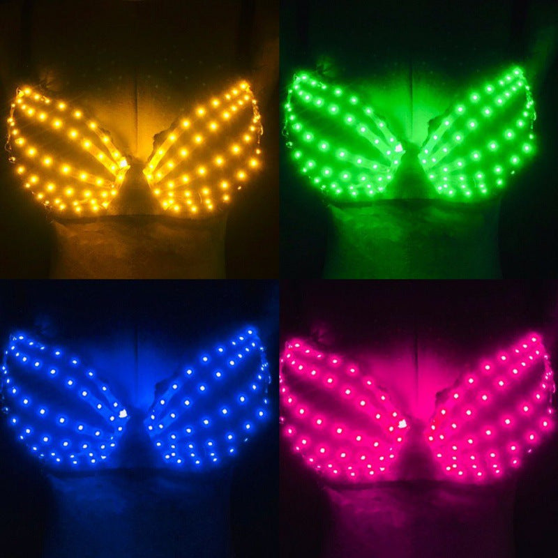 LED light-up bras in yellow, green, blue, and pink glowing on a mannequin torso in dark background