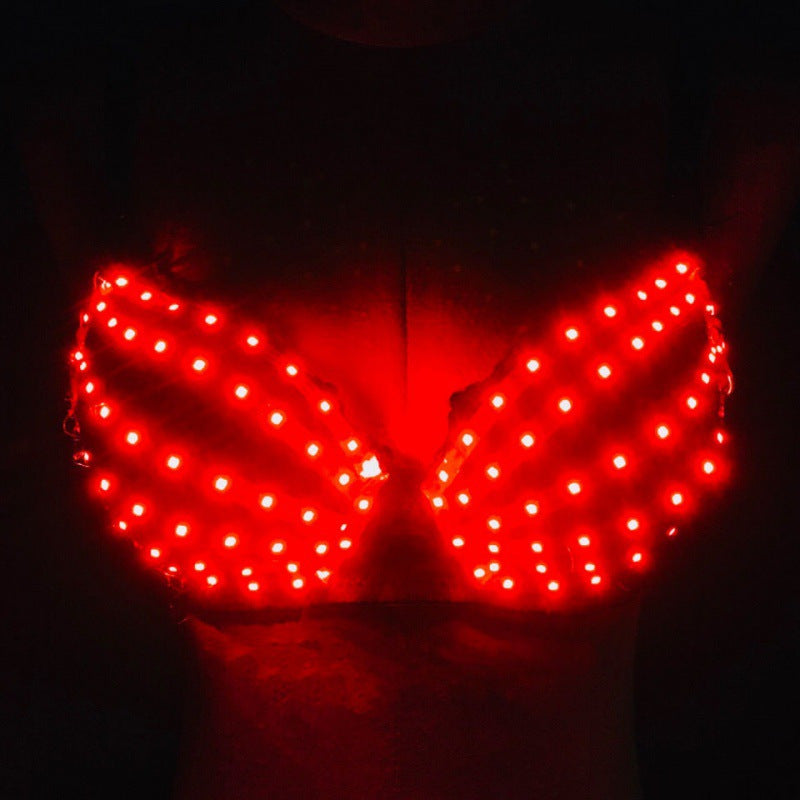 Red LED light-up bra with dotted pattern glowing brightly on dark background