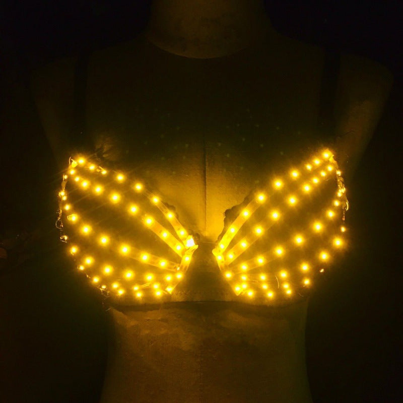 Yellow luminous cotton bra with LED lights on mannequin in dark background