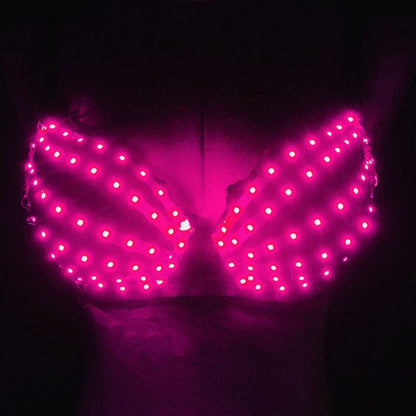 Luminous bra with bright pink LED lights glowing in dark background