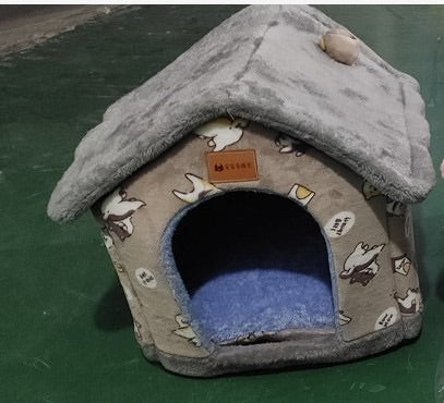 Small cozy pet nest shaped like a house with gray plush roof and cartoon dog pattern