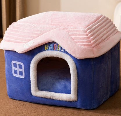 Soft blue and pink plush pet house with a roof design and window, cozy indoor pet bed