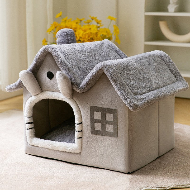 Gray plush cozy pet house with soft roof and window on beige carpet in bright room