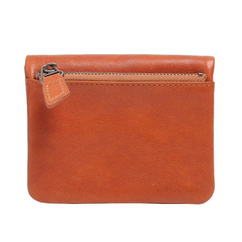 Compact brown leather zippered wallet with smooth vegetable-tanned cowhide surface