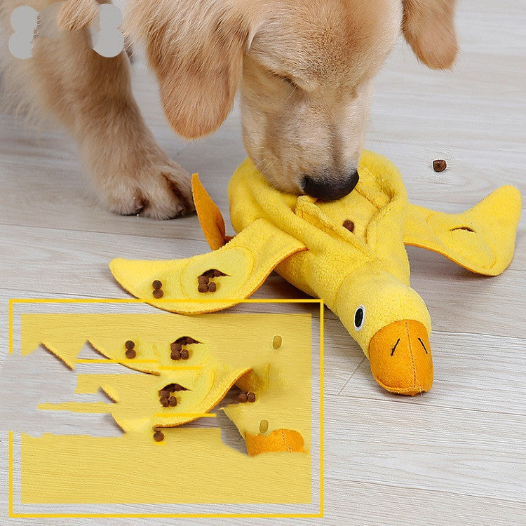 Golden retriever dog playing with a durable yellow duck plush squeaky toy on wooden floor