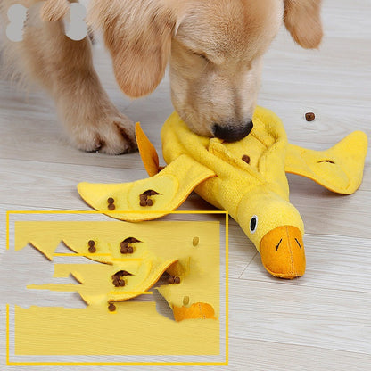 Golden retriever dog playing with a durable yellow duck plush squeaky toy on wooden floor