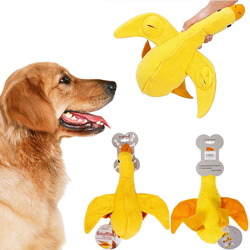 Golden retriever dog looking at a yellow plush duck squeaky chew toy for pets