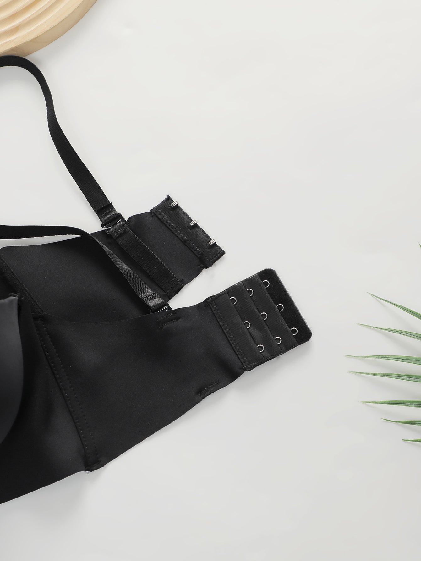 Black women's push-up bra with adjustable straps and multiple hook closures on white background