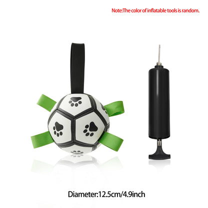 Durable dog football toy with paw prints and green handles, plus black air pump on white background