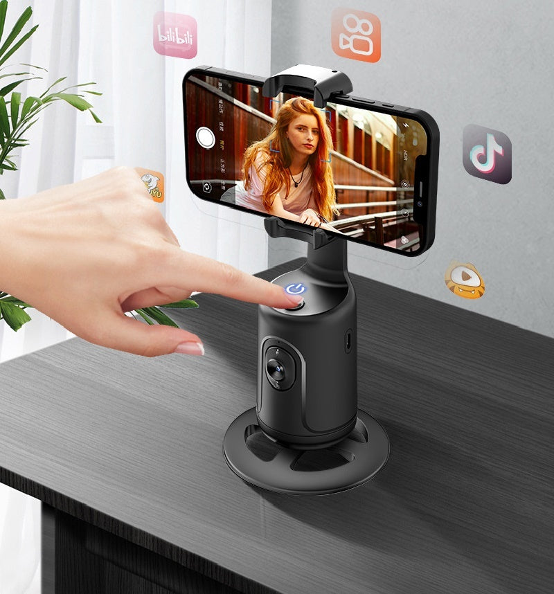 Black AI smart gimbal with 360-degree rotation holding a smartphone with auto face tracking, finger pressing power button