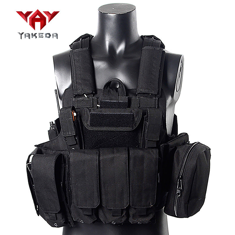 Black tactical combat vest with multiple pockets and pouches on mannequin torso