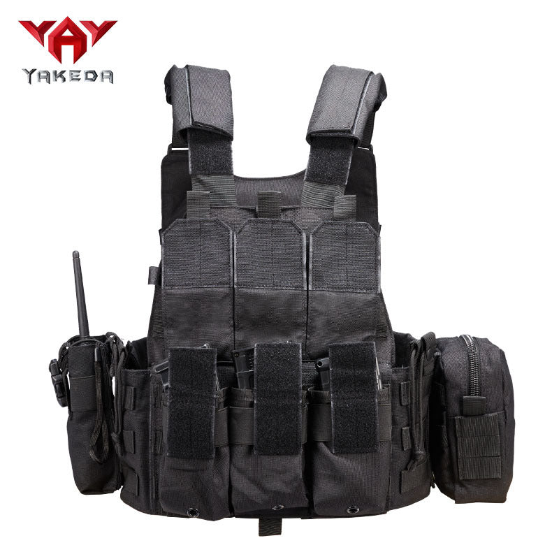Black tactical vest with three front magazine pouches, radio holder, and side utility pouch