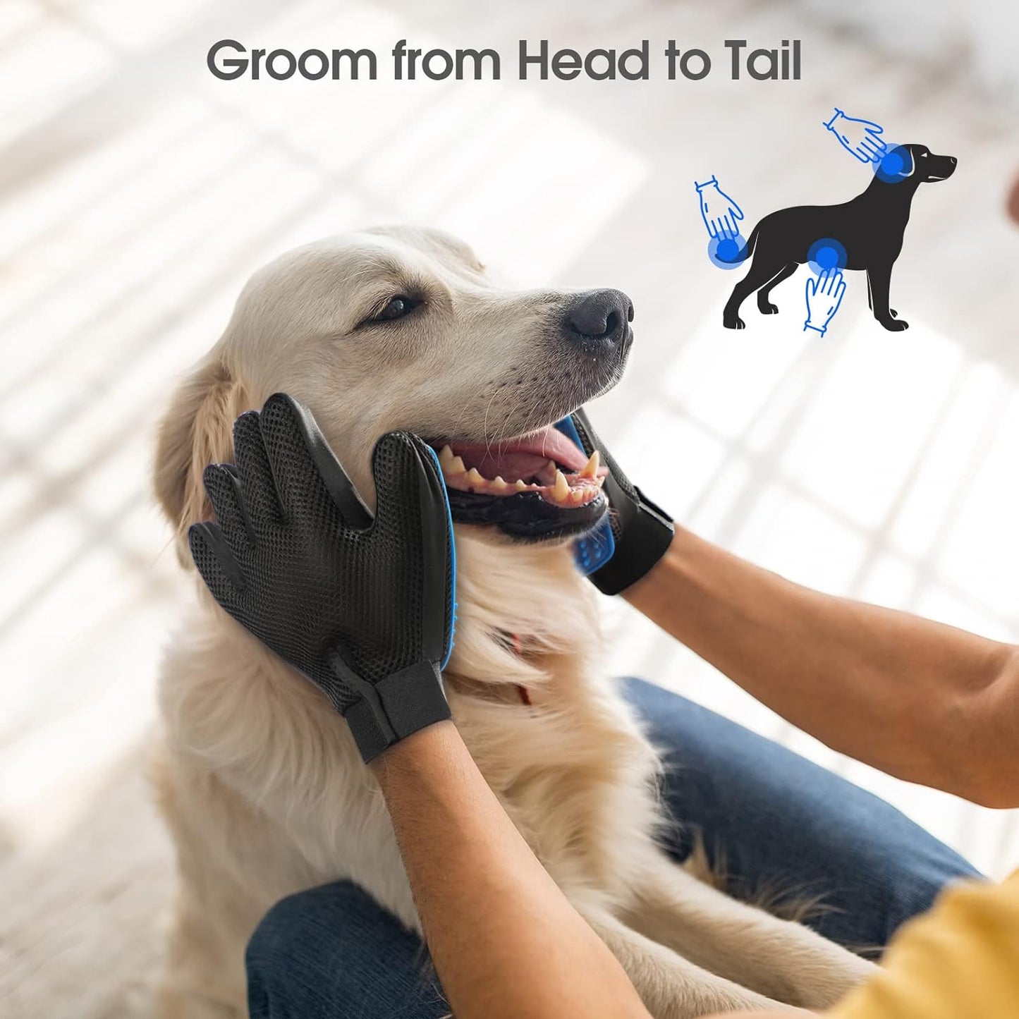 Person using black and blue silicone grooming gloves on a happy golden retriever indoors