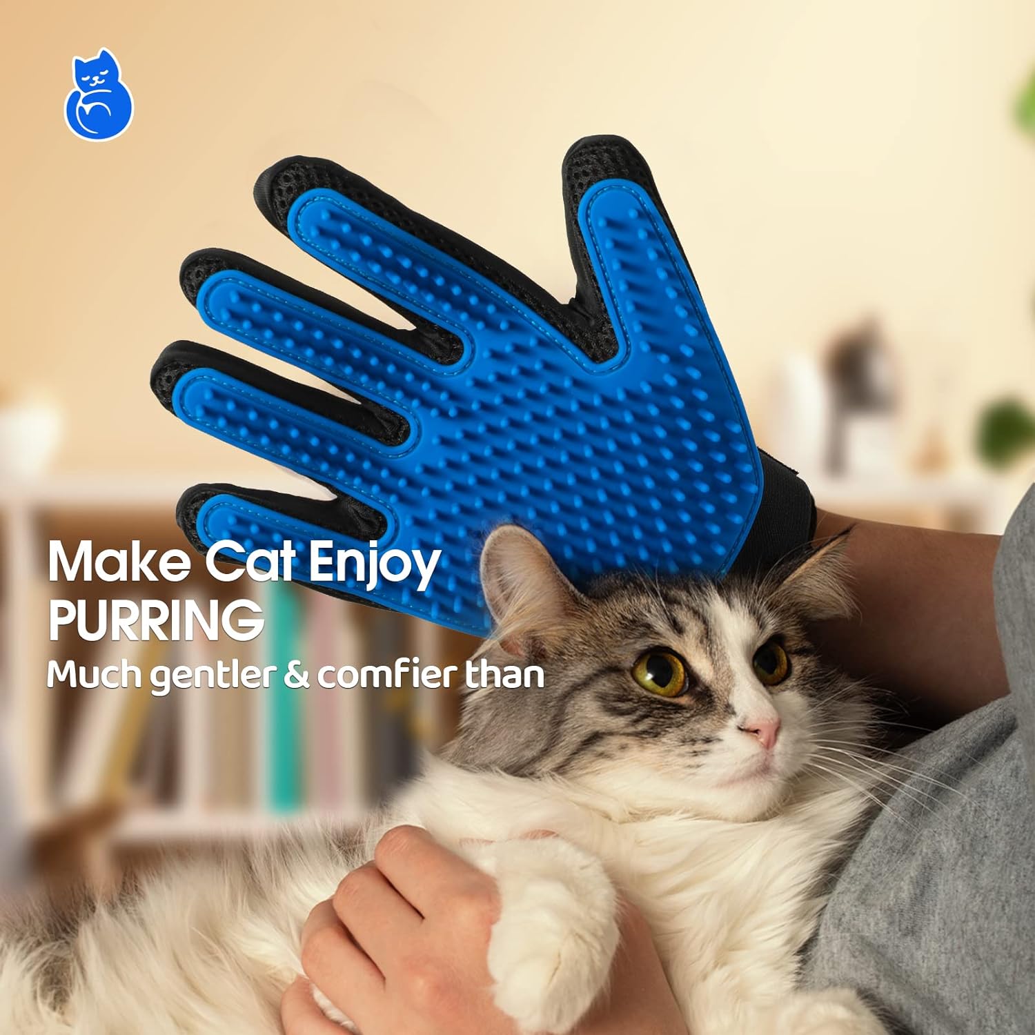 Blue silicone pet grooming glove for cats with adjustable strap, held near a fluffy cat