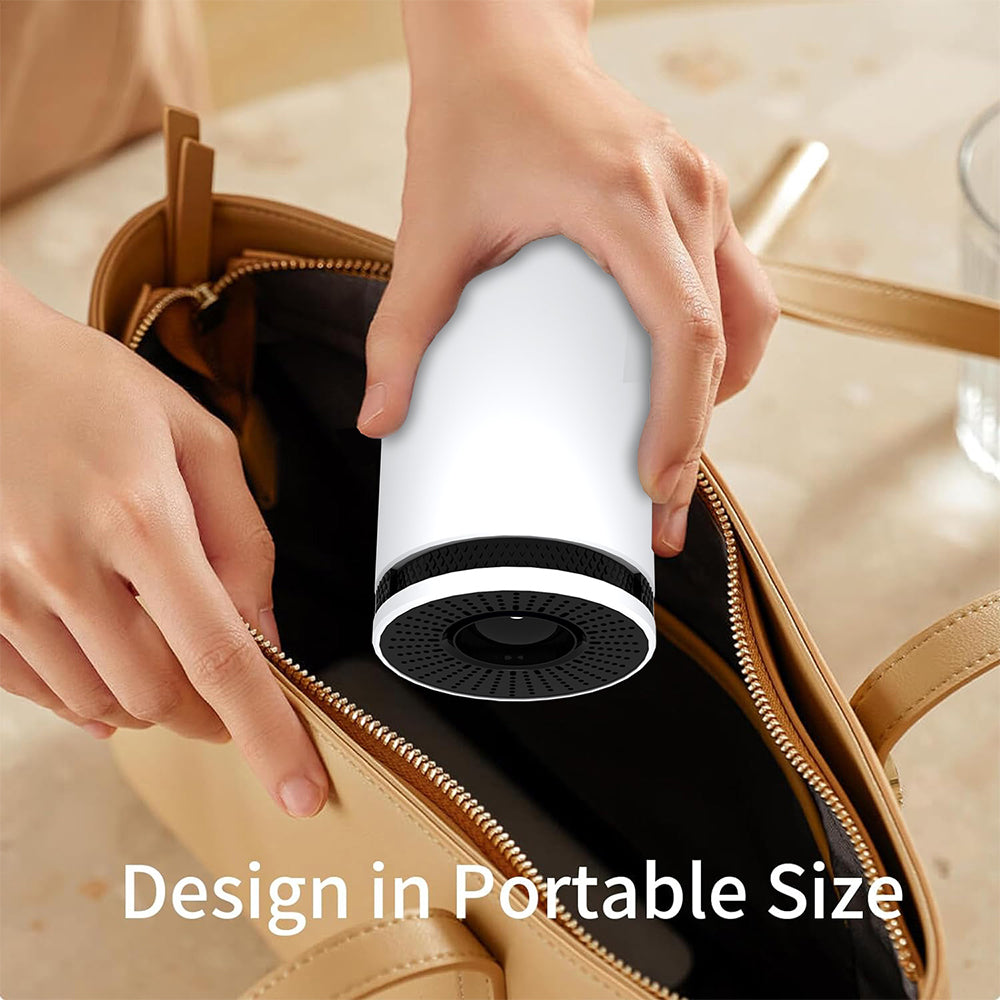 Hand placing a compact white portable mini projector into a tan handbag with text 'Design in Portable Size'