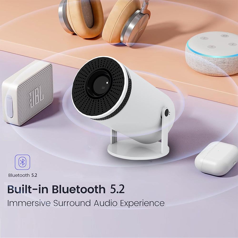 Mini projector with built-in Bluetooth 5.2, surrounded by headphones and speakers on table