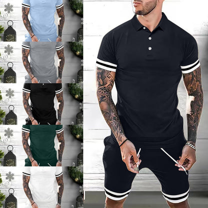 Tattooed man wearing black polo shirt and shorts set with white stripe details in casual indoor setting