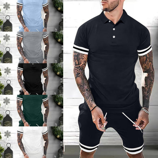 Tattooed man wearing black polo shirt and shorts set with white stripe details in casual indoor setting