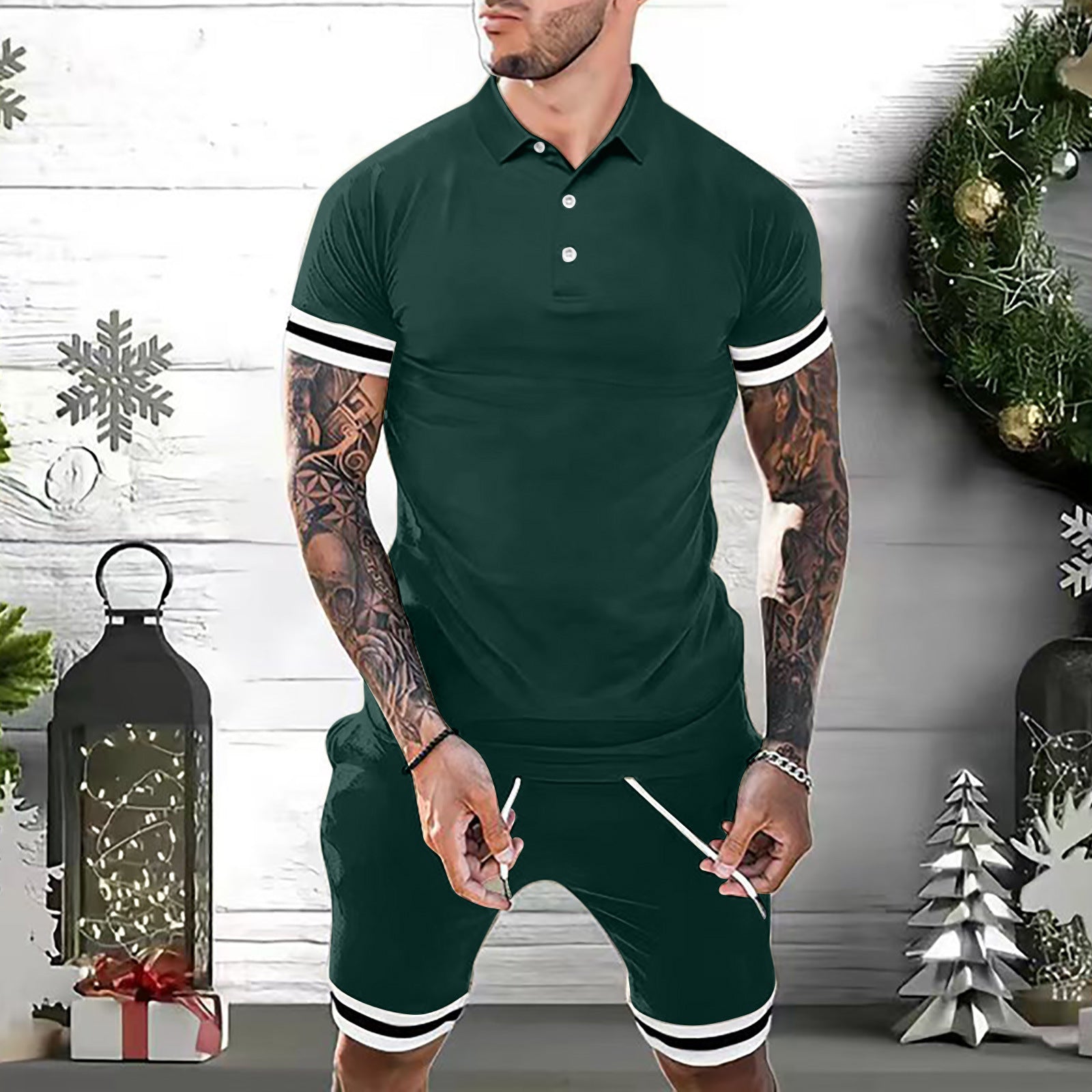 Man wearing green men's polo shorts set with white stripes, tattoos on arms, holiday decorations background