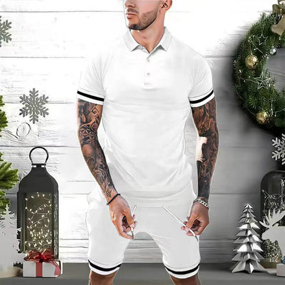 Man wearing white polo shirt and shorts with black stripes, standing in festive holiday setting