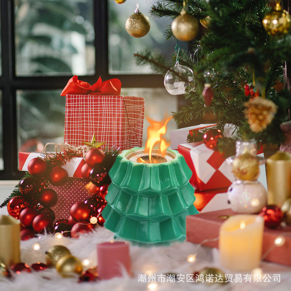 Green ceramic decorative alcohol fireplace with Christmas tree, red gifts, red wreath, and candles