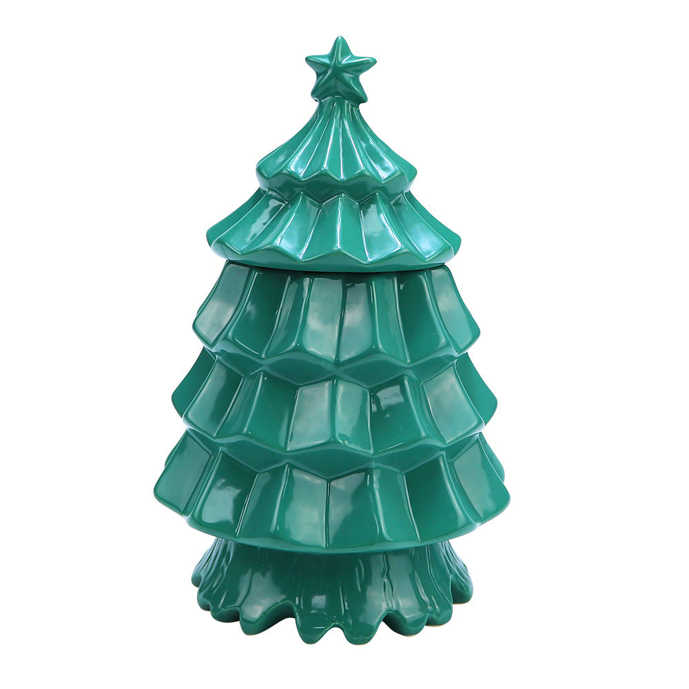 Glossy green ceramic Christmas tree decoration with star topper on white background