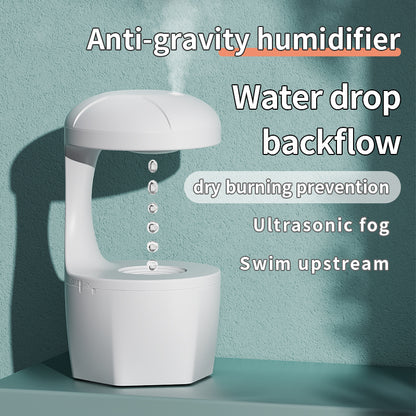 White anti-gravity humidifier with floating water drop design and ultrasonic fog on green background