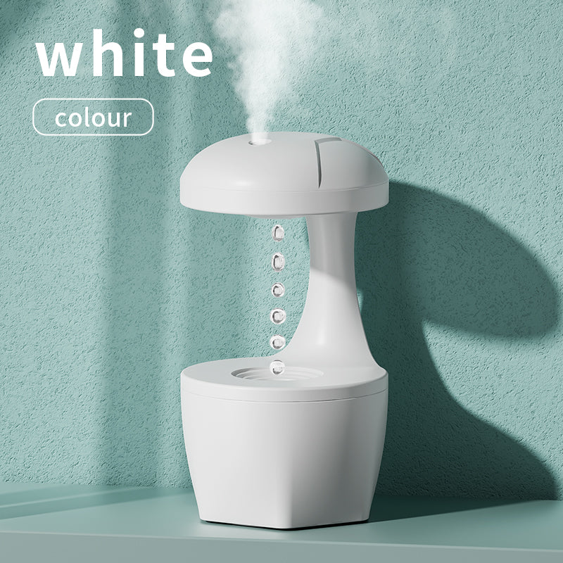White Trendoligy anti-gravity humidifier with cool mist and suspended water drops on a teal surface