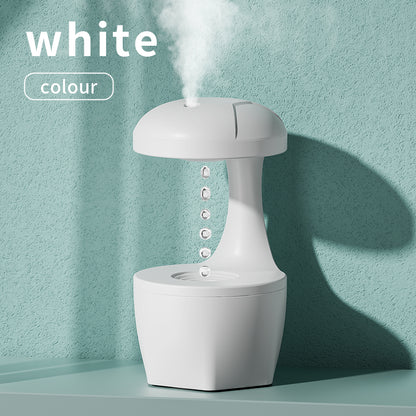 White Trendoligy anti-gravity humidifier with cool mist and suspended water drops on a teal surface