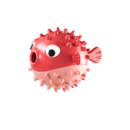 Red and pink spiky puffer fish dog chew toy with large eyes and tail on white background