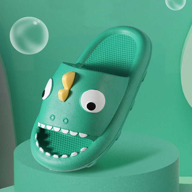 Green kids shower slipper with fun monster face design and non-slip sole on teal background