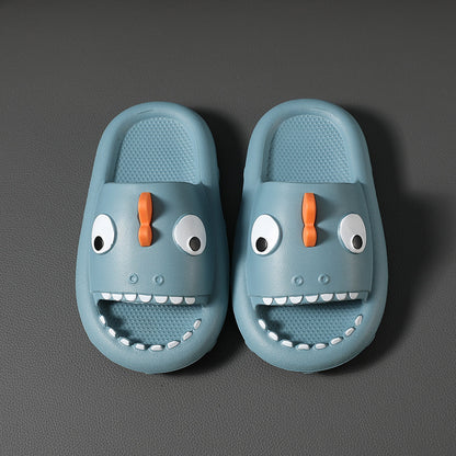 Blue kids shark slippers with orange fin and white teeth on gray background