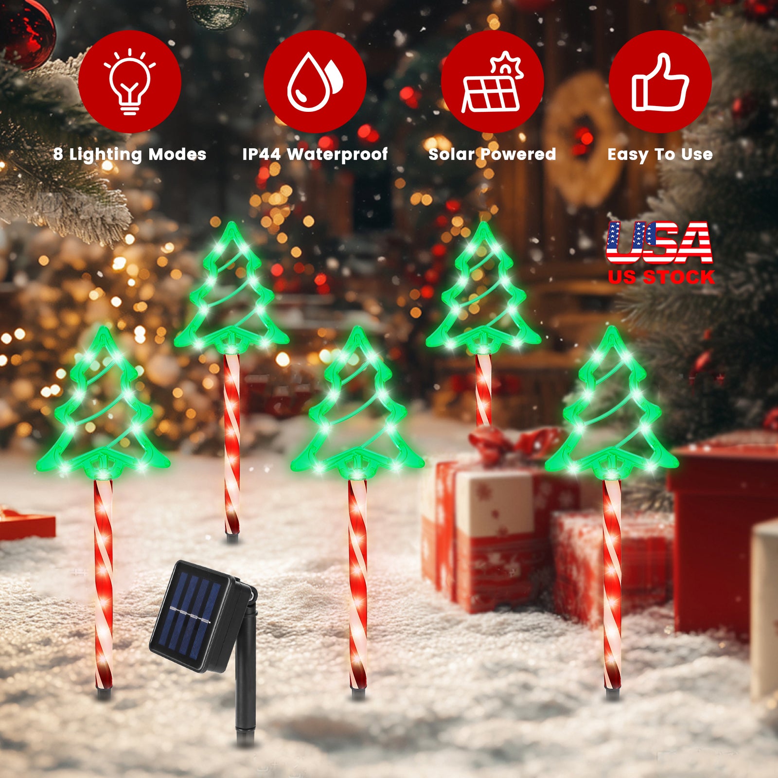 Solar powered Christmas tree pathway lights with red candy cane stakes in snowy festive setting