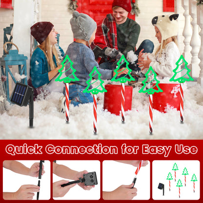 Family playing in snowy porch with solar-powered Christmas tree pathway lights and quick connect stakes