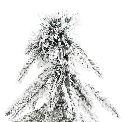 Close-up of white artificial Christmas tree branches with snow flocking detail
