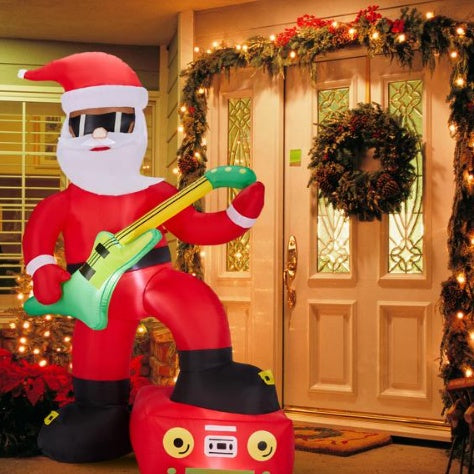 Inflatable Santa Claus wearing sunglasses playing green guitar with red boombox in decorated Christmas front porch