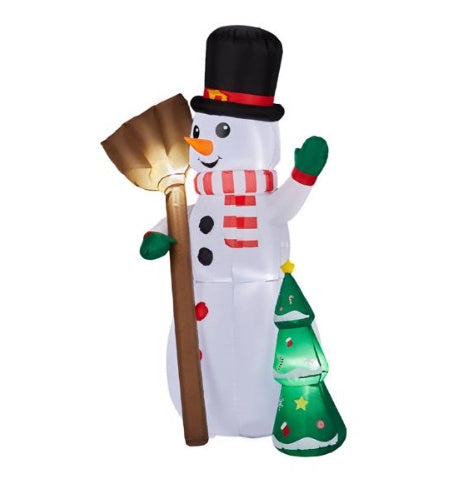 Inflatable LED snowman with black top hat, red striped scarf, green gloves, holding gold broom, next to decorated Christmas tree