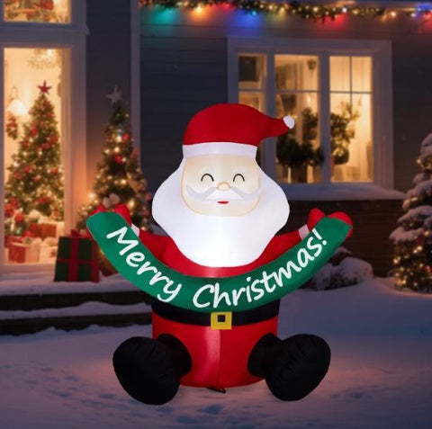 Inflatable 5.8ft seated Santa Claus holding a green Merry Christmas banner with 3 LED lights outdoors at night