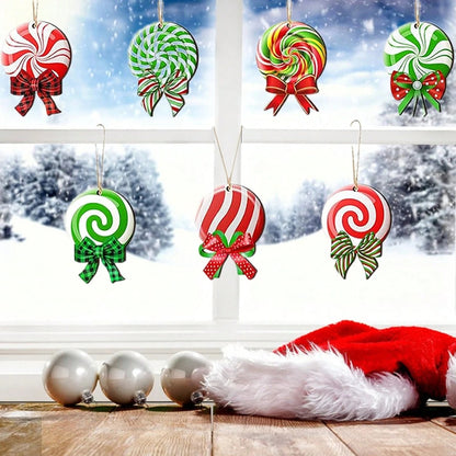 Colorful peppermint swirl Christmas ornaments with bows hanging on a window with snow outside
