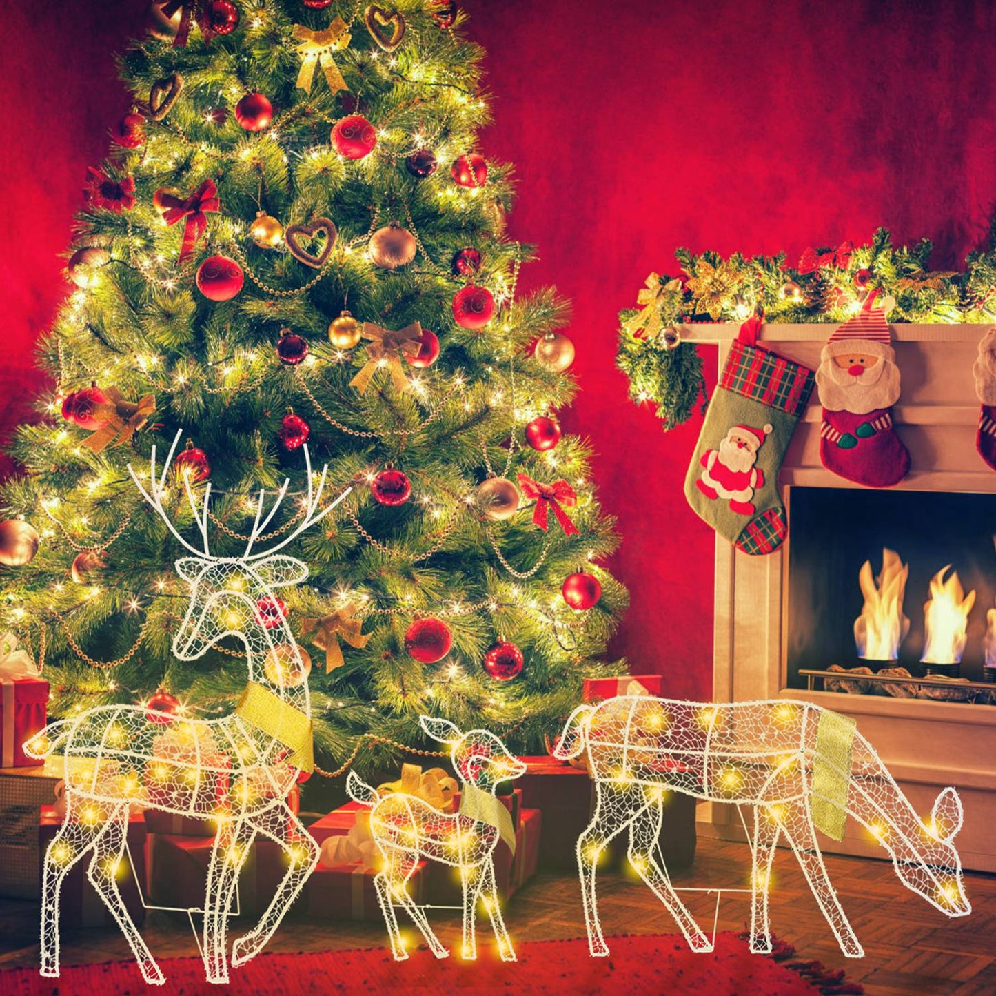 Lit wireframe reindeer family decorations by decorated Christmas tree and fireplace with stockings