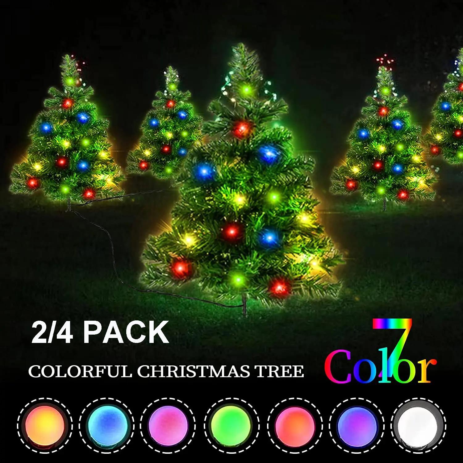 Outdoor solar Christmas trees with multicolor LED lights in red, blue, green, and yellow glowing at night