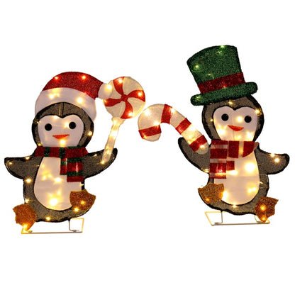 Two festive penguin Christmas decorations with warm white LED lights, one with a Santa hat and one with a green top hat