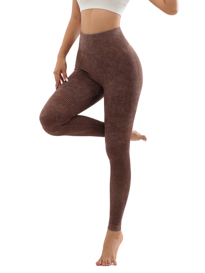 Woman wearing brown high-waisted seamless textured leggings, posing with one leg raised