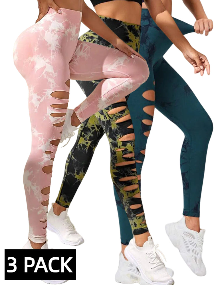 Three women wearing tie-dye cutout leggings in pink, green-black, and blue, paired with white sneakers