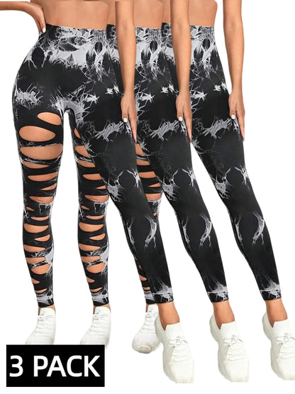 Three-pack of black and white tie-dye high-waist leggings with cut-out ripped details and white sneakers