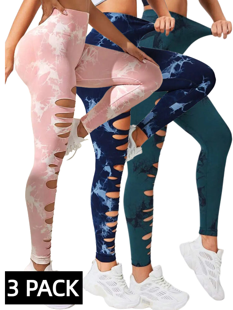 Three pairs of high-waist, tie-dye leggings in pink, navy blue, and dark green with side cut-outs, worn with white sneakers
