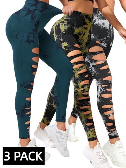 Three women wearing 3-pack of high-waist, butt-lifting yoga leggings with cut-out designs and tie-dye patterns