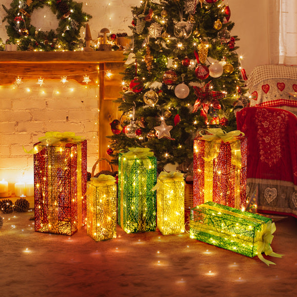 Warm white LED lighted gift boxes in red, green, and gold under Christmas tree with festive decorations